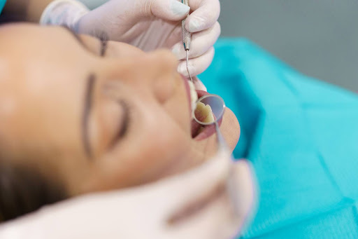 Dentist examining a patient's teeth during a checkup.