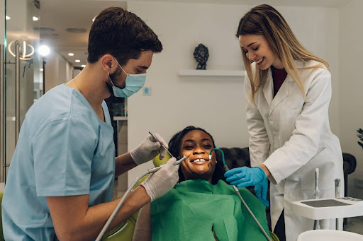A dentist and her hygienist provide general dentistry care to a patient.