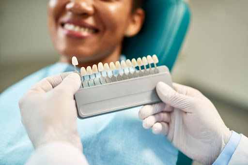 A dentist is finding the best fit for tooth replacements.